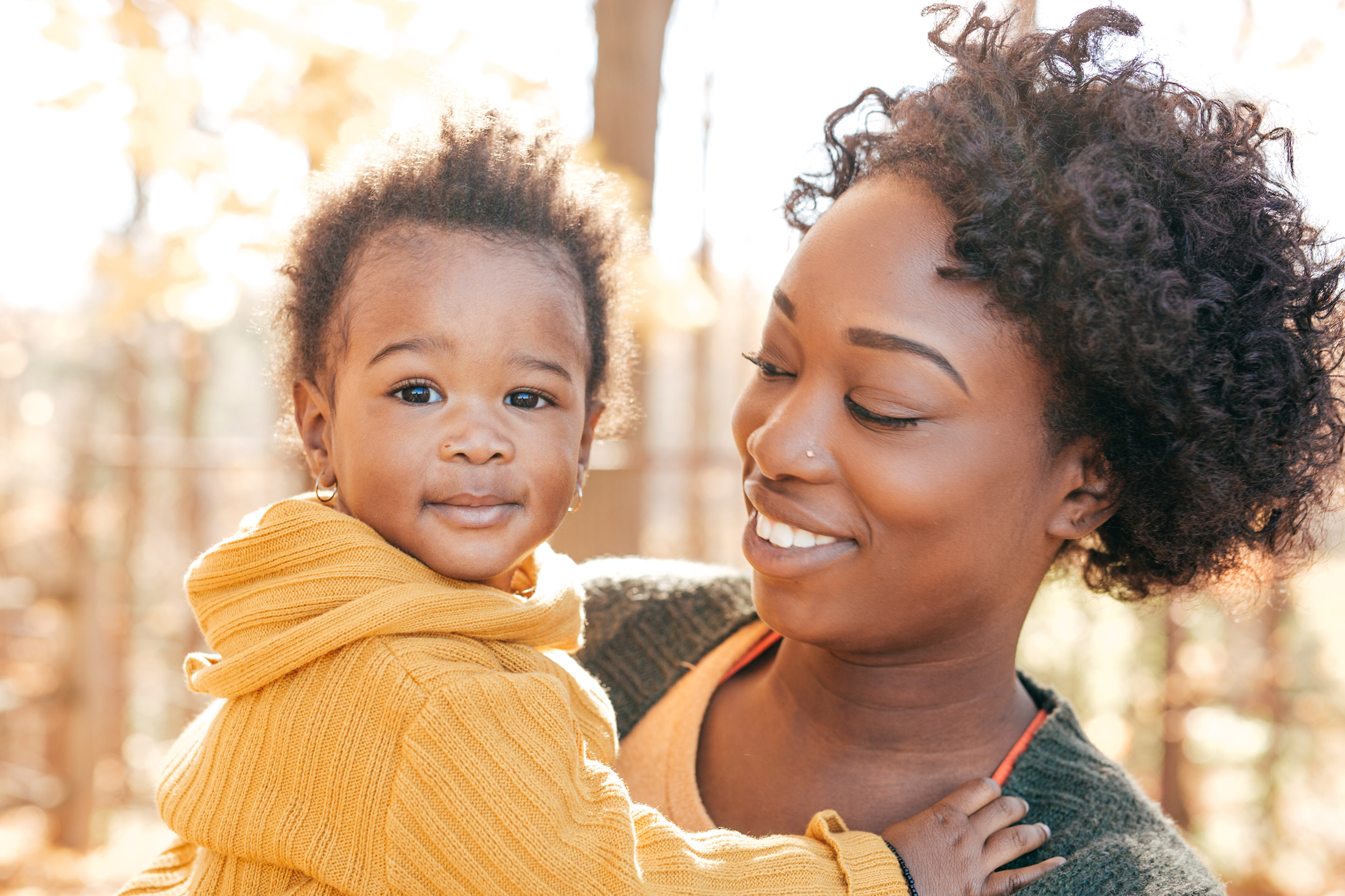 A woman holding and infant